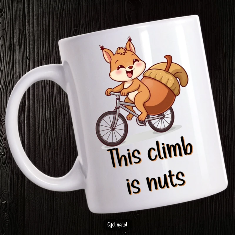 Funny squirrel mug showing a determined but struggling squirrel pedaling a bike uphill with a massive acorn.