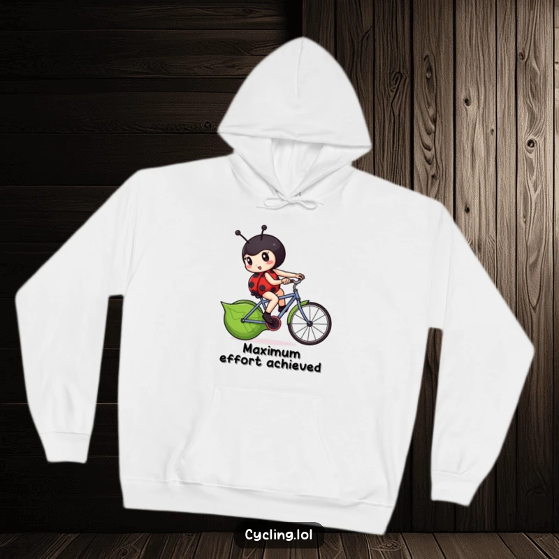 Funny ladybug hoodie showing a determined ladybug furiously pedaling a leaf-shaped bicycle, perfect for cozy motivation.