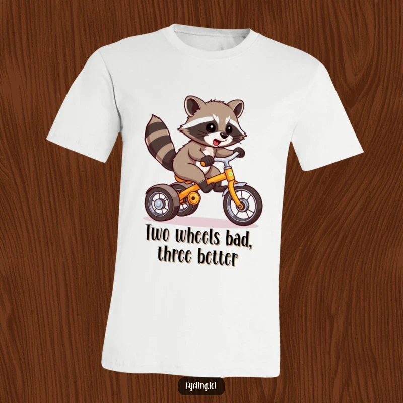 Funny Raccoon T-Shirt: A mischievous raccoon attempts a daring wheelie on a tricycle, capturing a moment of pure, hilarious chaos.
